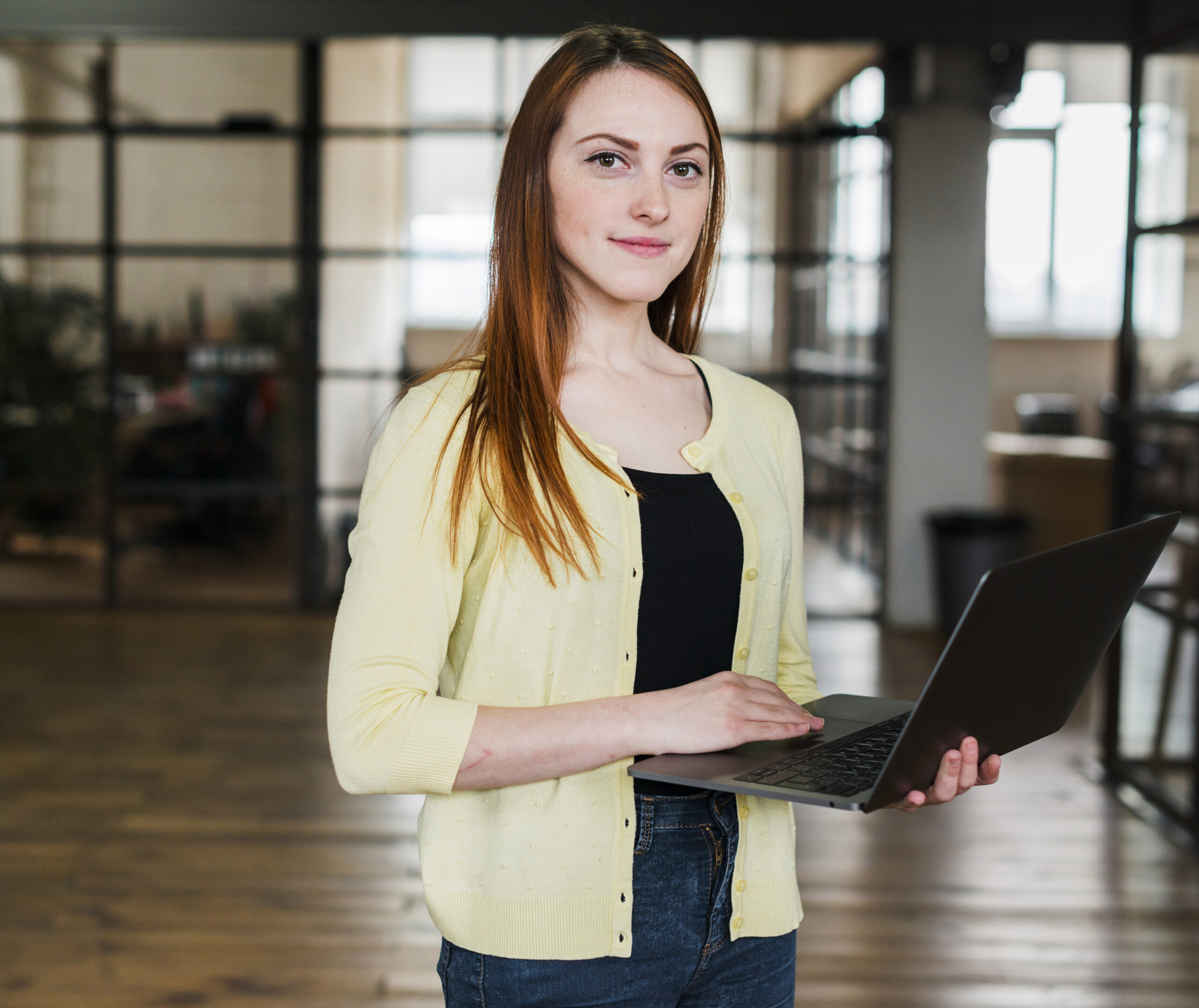portrait-pretty-woman-holding-laptop-looking-camera